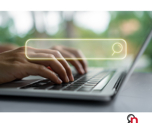 someone typing on a computer to find online media mentions